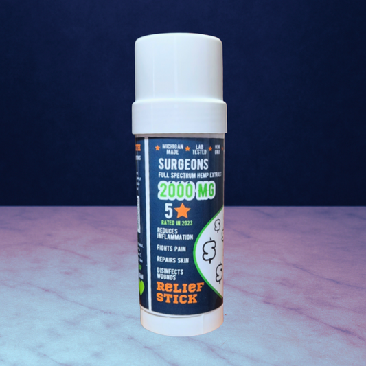 Pain Relief and muscle recovery "Relief Stick" resting on top of purple granite background