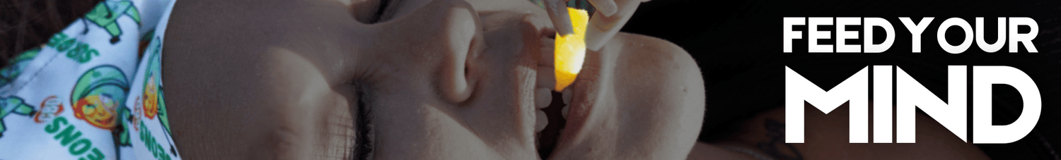 Woman inserting a Surgeons gummy bear into her mouth with her teeth around the edible like she is about to take a bite.